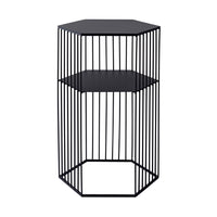 The Hendrix Bedside Table, a two-level hexagonal wireframe piece, features vertical black metal bars in a modern design. Made from black powder-coated iron, it serves as both a minimalist stool and stylish bedside table.