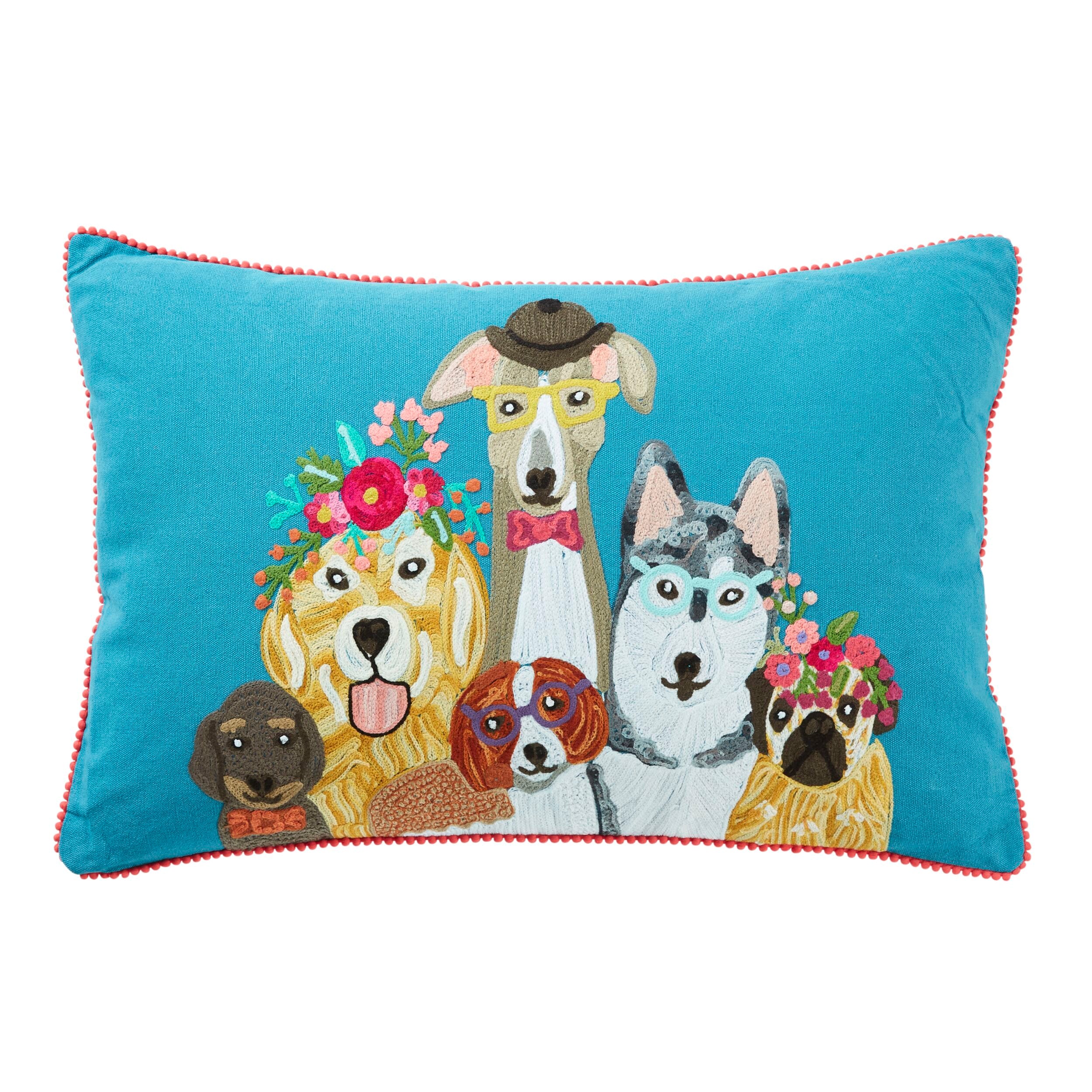 The "Stitch Dogs Life Cushion 60x40cm" showcases a decorative pillow embellished with illustrations of six dogs in vibrant accessories set against a blue background, providing an appealing animal-themed design.