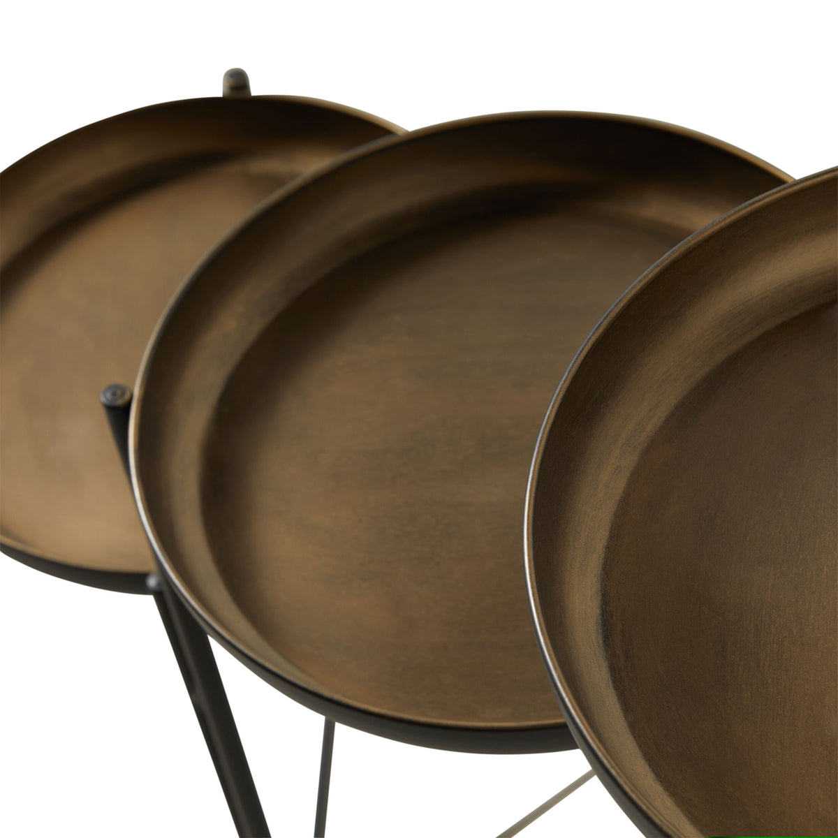 Close-up of three overlapping bronze-finish trays with durable metal construction, each on a thin black stand, from the Gracie Tiered Side Table 34x31x80cm, set against a white background.