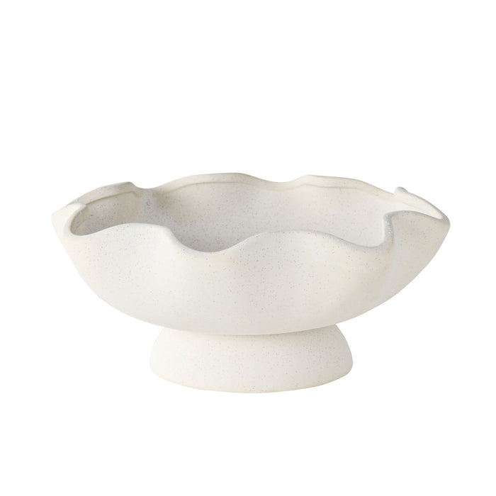 The Tranquil Wavy Pedestal Bowl features a white sand clay finish, wavy scalloped edge, and short pedestal base, making it a charming decorative centrepiece against a plain background.