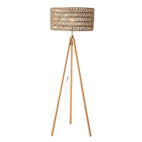 The Lexi Seagrass Natural Tripod Floor Lamp (165x45cm) features a woven rattan shade, wooden tripod base, and visible power cord with inline switch, bringing coastal-inspired lighting to your space.