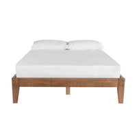 The Kyan Double Bed Base in chestnut features a timber frame, displayed front-facing, and supports a white mattress along with two plush white pillows.