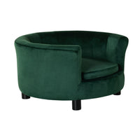 The Vivienne Velvet Pet Bed in Forest features a round, modern design with plush padding and short black cylindrical legs, plus an open front and wraparound backrest for elevated pet comfort. Size: 65x65x36cm.